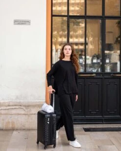 Traveler Tee Pant -Mersea Sales Store womens black wide leg ankle side slit elastic waist pant front view full body travel destination look