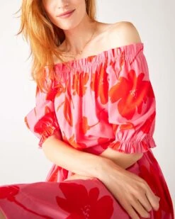 Ibiza Dress -Mersea Sales Store womens floral pink ruffled shoulder midi dress sitting front view arms crossed