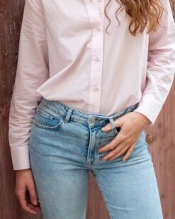 Nomad Cropped Mini Boot Jean 23 Nomad Cropped Mini Boot Jean -Mersea Sales Store womens light blue 5 pocket universal mid rise fit wide leg stretchy cropped mini boot jeans front view close up waist line detail