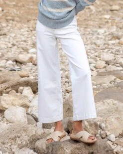 Nomad Cropped Sailor Jean -Mersea Sales Store womens white cropped sailor jean front view rocky beach