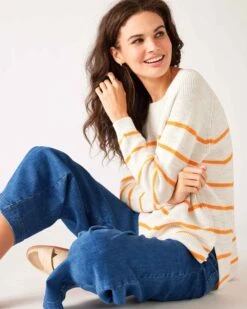 Camden Boatneck Sweater -Mersea Sales Store womens white orange stripes midweight sweater sitting side view arms crossed